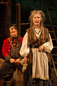 The Hostess (Marion Adler) delivers a eulogy for Sir John Falstaff as her husband Pistol looks on in Shakespeare Santa Cruz’s 2013 production of Henry V. photo rrjones